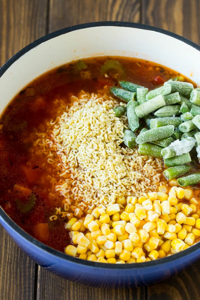 Alphabet Soup Recipe | Hamburger Soup | Beef and Vegetable Soup #soup #hamburger #noodles #dinner #edsug #carrots A pot with noodles, broth, frozen corn and frozen green beans.