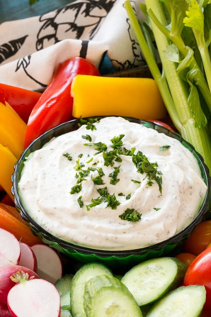 Homemade Ranch Dip Recipe | Homemade Ranch Powder | Homemade Ranch Dressing | Best Ranch Dip #ranch #dip #appetizer #snack #edsug A bowl of dip topped with chopped parsley and surrounded by vegetables.