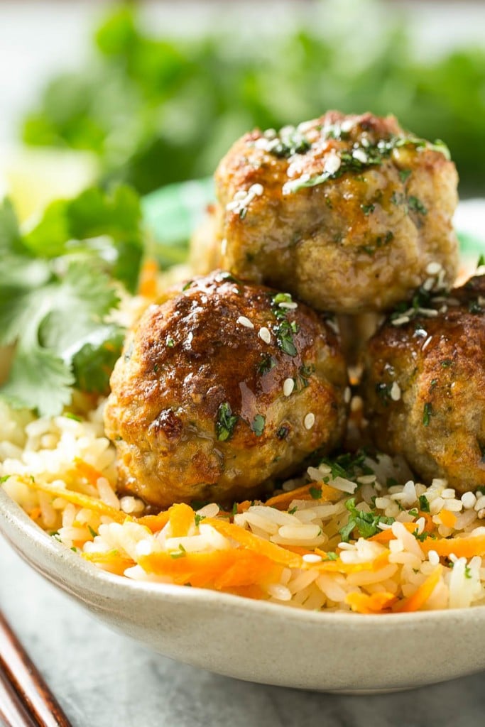 This recipe for asian turkey meatballs involves light and tender meatballs that are seasoned with asian flavors, tossed in a honey garlic sauce and served over a colorful carrot rice. It's a quick and easy weeknight meal that the whole family will love!