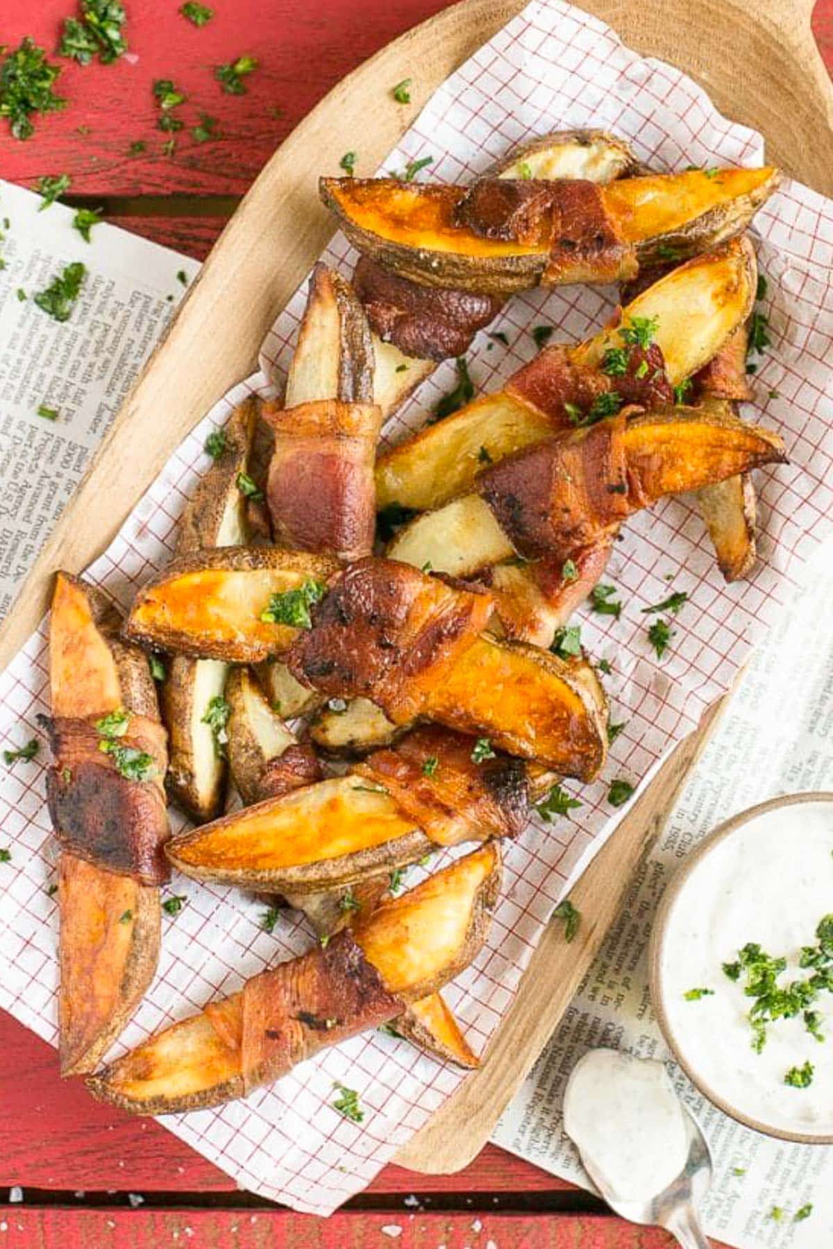 Bacon Wrapped Potato Wedges Recipe | Best Potato Wedges | Bacon Wrapped French Fries | Bacon Potato Wedges #bacon #potato #fries #dinner #edsug Potato wedges on a sheet of parchment paper that have been roasted.