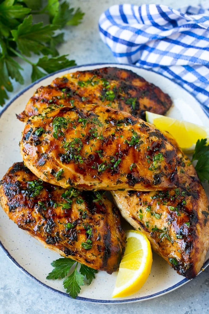Grilled Chicken Breast Recipe | Marinated Chicken Breast | Chicken Marinade #chicken #grilling #marinade #summer #dinner #edsug A platter of grilled chicken breast served with parsley and lemon.