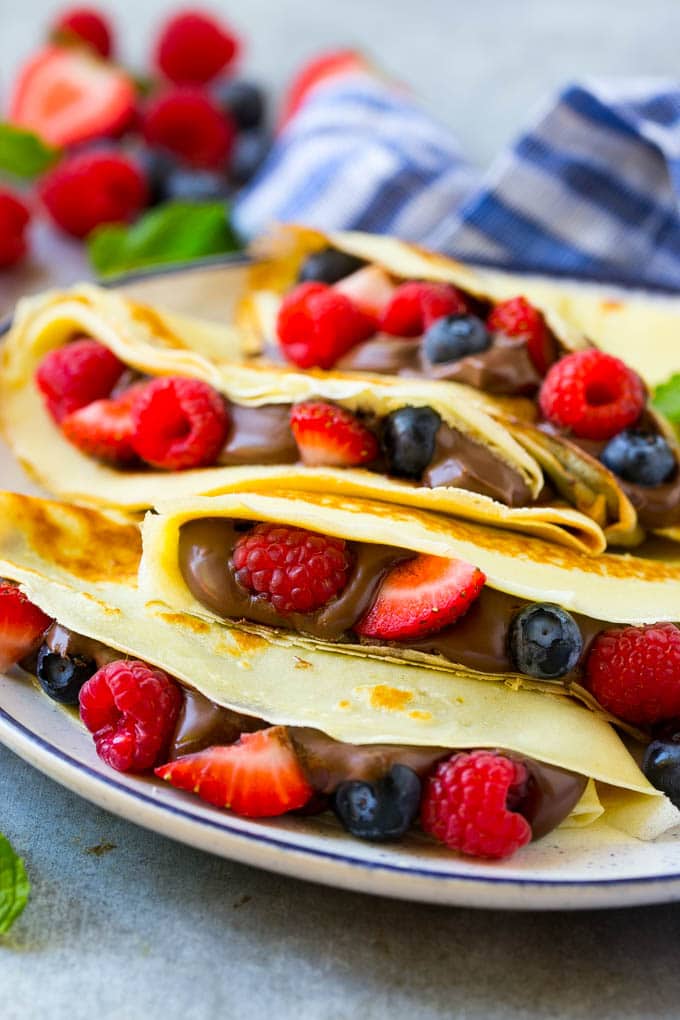 Nutella Crepes Recipe | Easy Crepes Recipe | Blender Crepes | Berry Crepes #crepes #nutella #nutellacrepes #blendercrepes #breakfast #edsug A stack of crepes that are stuffed full of chocolate Nutella spread and fresh berries.