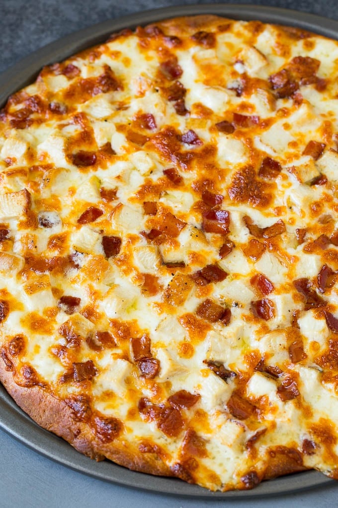 A baked crust topped with melted cheese and meat.