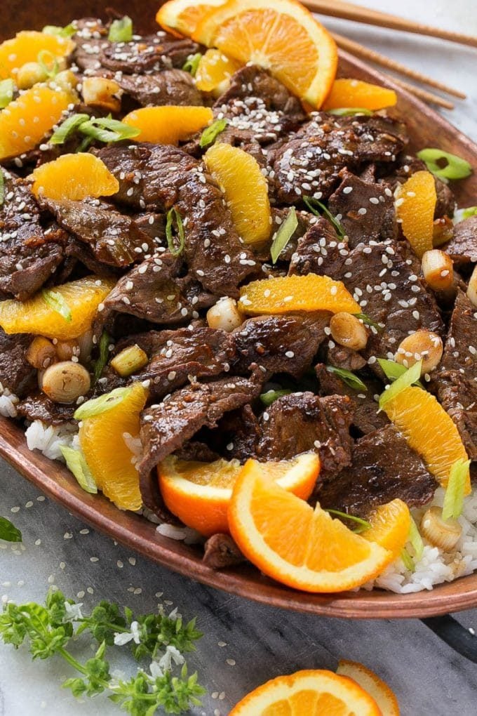Orange Beef Stir Fry Recipe | 4 Ingredient Orange Beef | Easy Orange Beef #orange #beef #stirfry #asian #dinner #edsug Orange beef topped with green onions and sesame seeds.