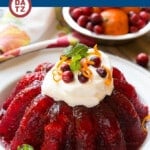 This cranberry Jello salad recipe combines raspberry gelatin with cranberry sauce, pineapple and orange zest for a delicious side dish or dessert that's perfect for the holidays.