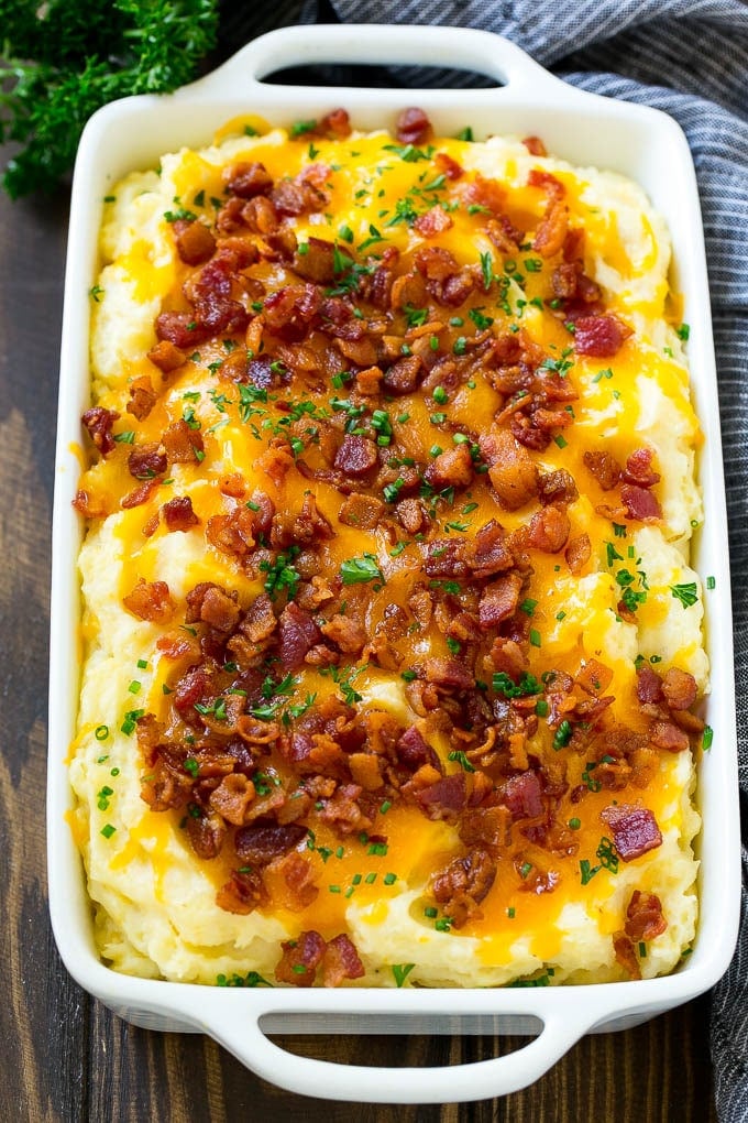 Loaded Mashed Potato Casserole Recipe | Loaded Potatoes | Bacon Mashed Potatoes | Thanksgiving Mashed Potatoes #potatoes #bacon #cheese #casserole #Thanksgiving #dinner #edsug Loaded mashed potato casserole topped with melted cheese, bacon and herbs.