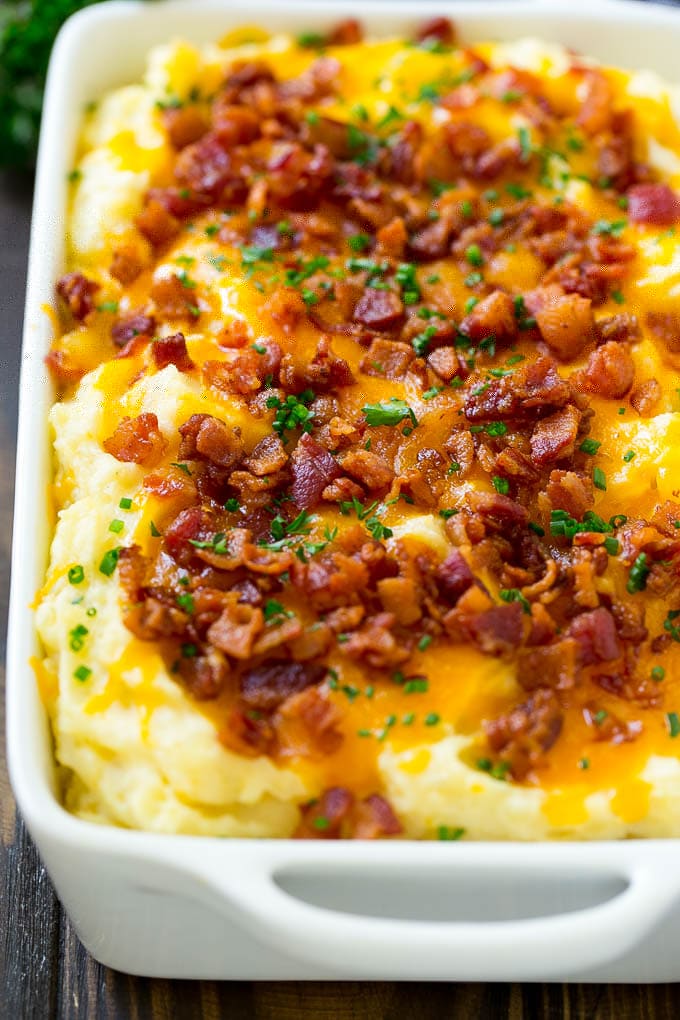 Loaded Mashed Potato Casserole Recipe | Loaded Potatoes | Bacon Mashed Potatoes | Thanksgiving Mashed Potatoes #potatoes #bacon #cheese #casserole #Thanksgiving #dinner #edsug A casserole of loaded mashed potatoes topped with cheddar cheese, crispy bacon and chives.