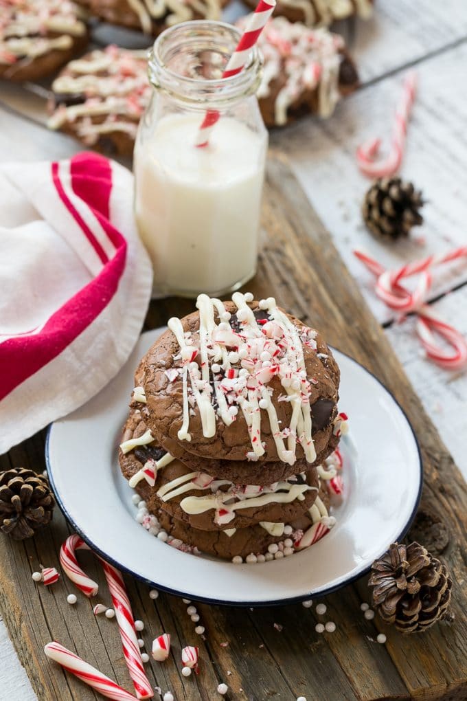 Peppermint Bark Cookie | Easy Peppermint Bark Cookies | Christmas Cookies | Peppermint Bark Cookies | Chocolate Peppermint Cookie #peppermint #peppermintbark #cookies #christmas #holiday #dessert #edsug A plate of chocolate peppermint bark cookies with a bottle of milk on the side.