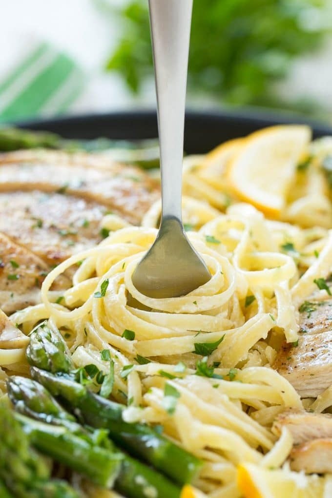 Lemon Asparagus Pasta with Grilled Chicken Recipe | Asparagus Pasta | Grilled Chicken Pasta | Easy Pasta Recipe #pasta #asparagus #lemon #chicken #dinner #edsug A fork serving up a portion of creamy pasta.