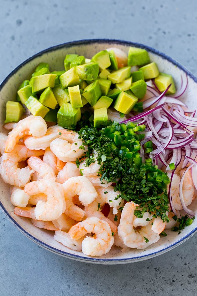 Mexican Shrimp Cocktail Recipe | Coctel de Camarones | Shrimp Cocktail | Mexican Shrimp #shrimp #appetizer #avocado #mexican #edsug Shrimp, red onion, avocado, jalapeno and cilantro in a serving bowl.