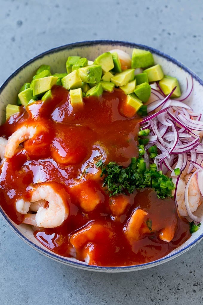 Mexican Shrimp Cocktail Recipe | Coctel de Camarones | Shrimp Cocktail | Mexican Shrimp #shrimp #appetizer #avocado #mexican #edsug Shrimp, avocado, red onion and cilantro topped with cocktail sauce.