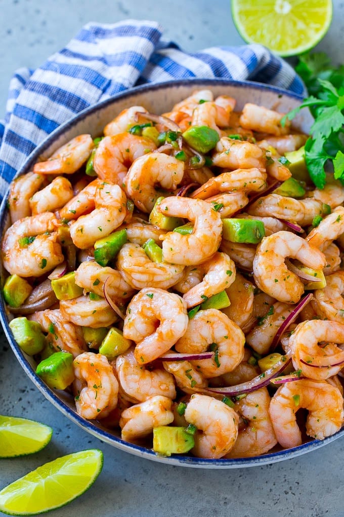 Mexican Shrimp Cocktail Recipe | Coctel de Camarones | Shrimp Cocktail | Mexican Shrimp #shrimp #appetizer #avocado #mexican #edsug A bowl of Mexican shrimp cocktail with red onion, avocado, homemade sauce and cilantro.