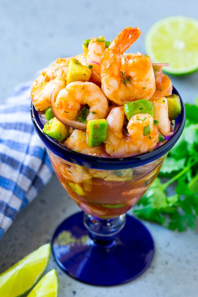 Mexican Shrimp Cocktail Recipe | Coctel de Camarones | Shrimp Cocktail | Mexican Shrimp #shrimp #appetizer #avocado #mexican #edsug An individual cup of Mexican shrimp cocktail with red onion and avocado.