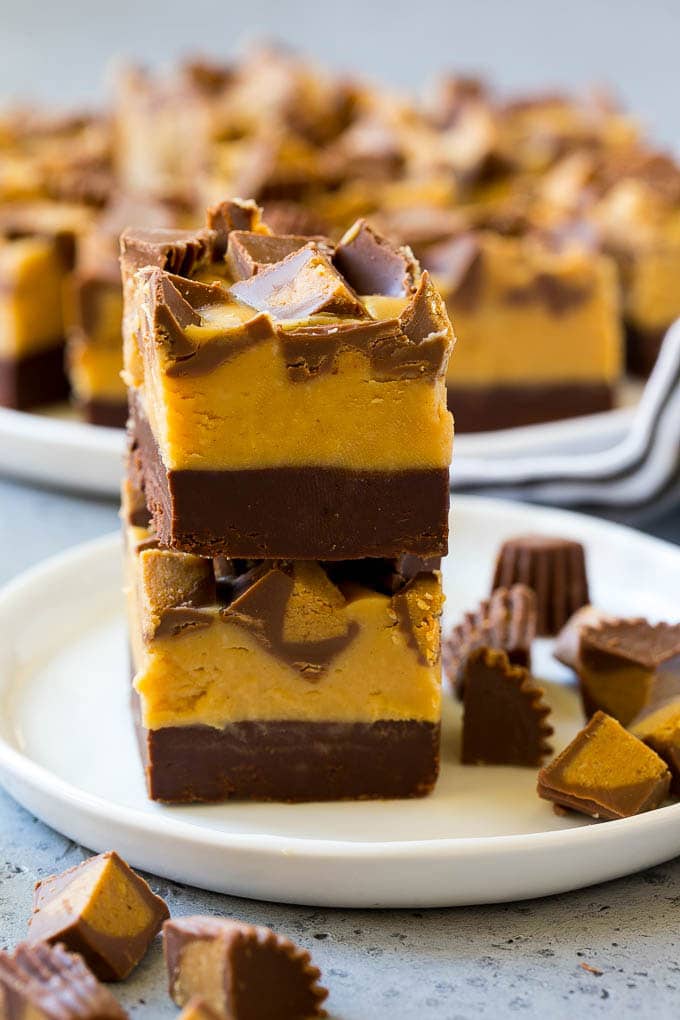 Chocolate Peanut Butter Fudge Recipe | Peanut Butter Cup Fudge | Easy Fudge Recipe #chocolate #peanutbutter #fudge #baking #dessert #edsug Stacked pieces of chocolate peanut butter fudge on a plate.