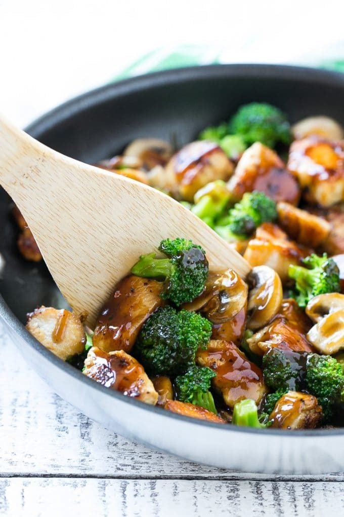 Chicken and Broccoli Stir Fry Recipe | Chicken Stir Fry | Healthy Chicken Recipe | Chicken and Broccoli | Chinese Food #chicken #broccoli #stirfry #healthy #cleaneating #dinner #edsug A spatula scooping chicken stir fry out of a pan.