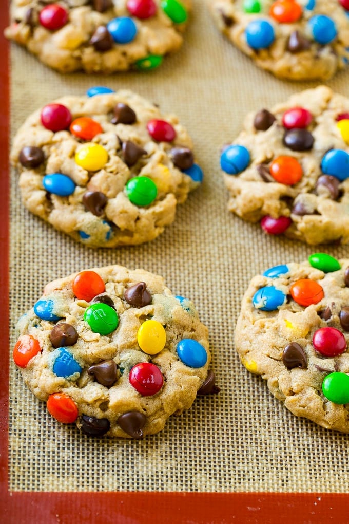 Monster Cookies Recipe | Oatmeal Cookies | Peanut Butter Cookies | M&M's Cookies #baking #cookies #dessert #peanutbutter #chocolate #edsug Baked monster cookies on a sheet pan.