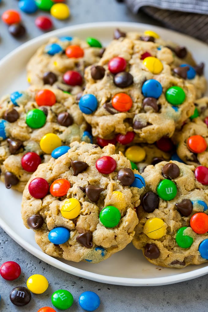 Monster Cookies Recipe | Oatmeal Cookies | Peanut Butter Cookies | M&M's Cookies #baking #cookies #dessert #peanutbutter #chocolate #edsug A plate of monster cookies which are made with oats, peanut butter, chocolate chips and M&M's.