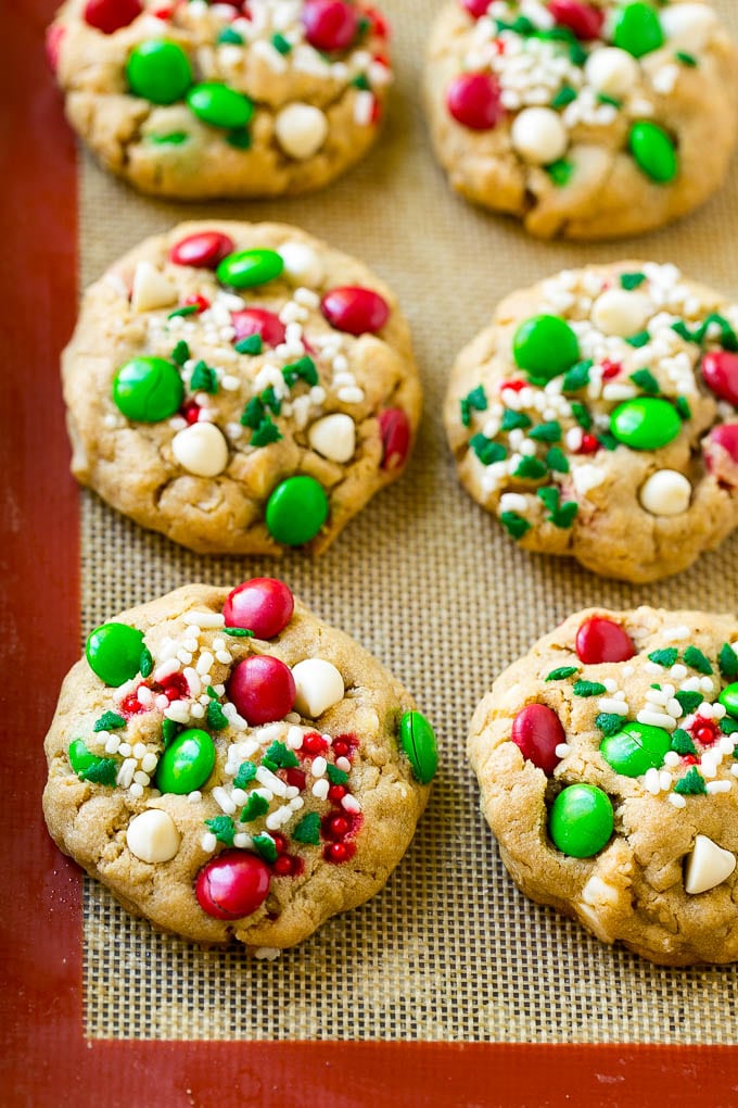 Christmas Monster Cookies Recipe | Oatmeal Cookies | Peanut Butter Cookies | M&M's Cookies #baking #cookies #dessert #peanutbutter #chocolate #edsug #christmas #sprinkles Baked Christmas cookies on a sheet pan.