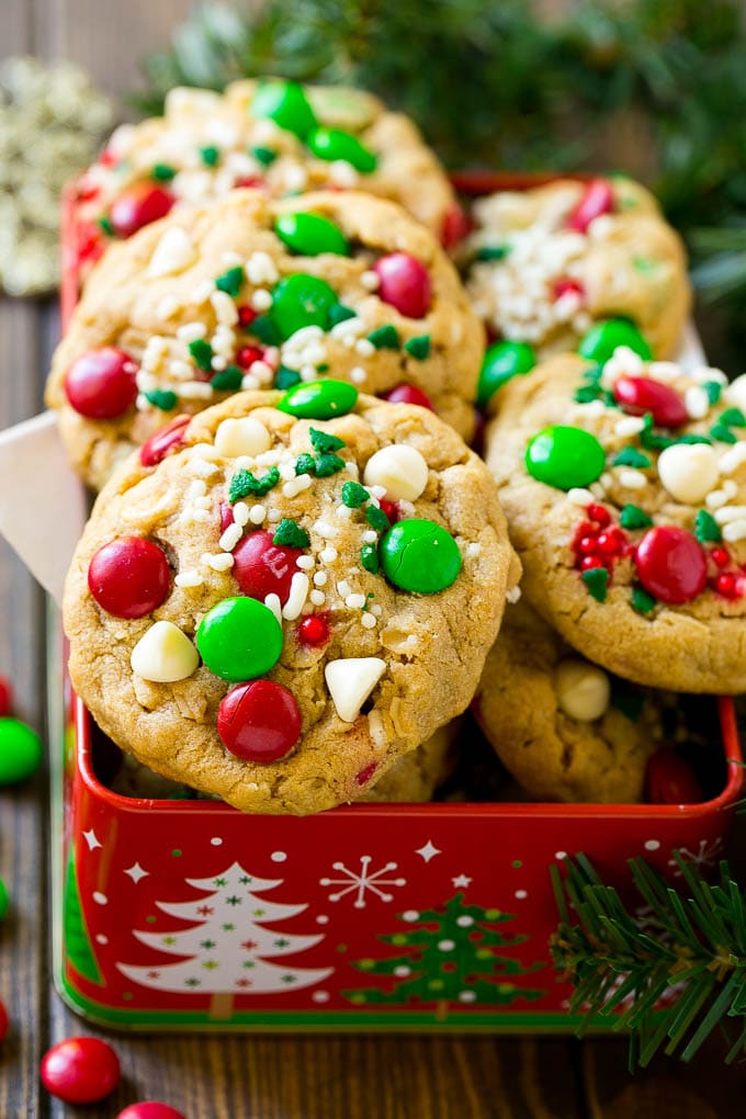 Christmas Monster Cookies Recipe | Oatmeal Cookies | Peanut Butter Cookies | M&M's Cookies #baking #cookies #dessert #peanutbutter #chocolate #edsug #christmas #sprinkles Christmas monster cookies in a gift tin.