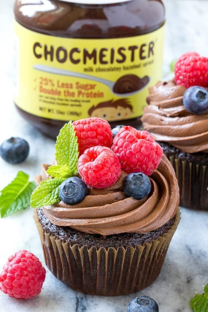 Nutella cupcakes with creamy frosting, raspberries and blueberries.
