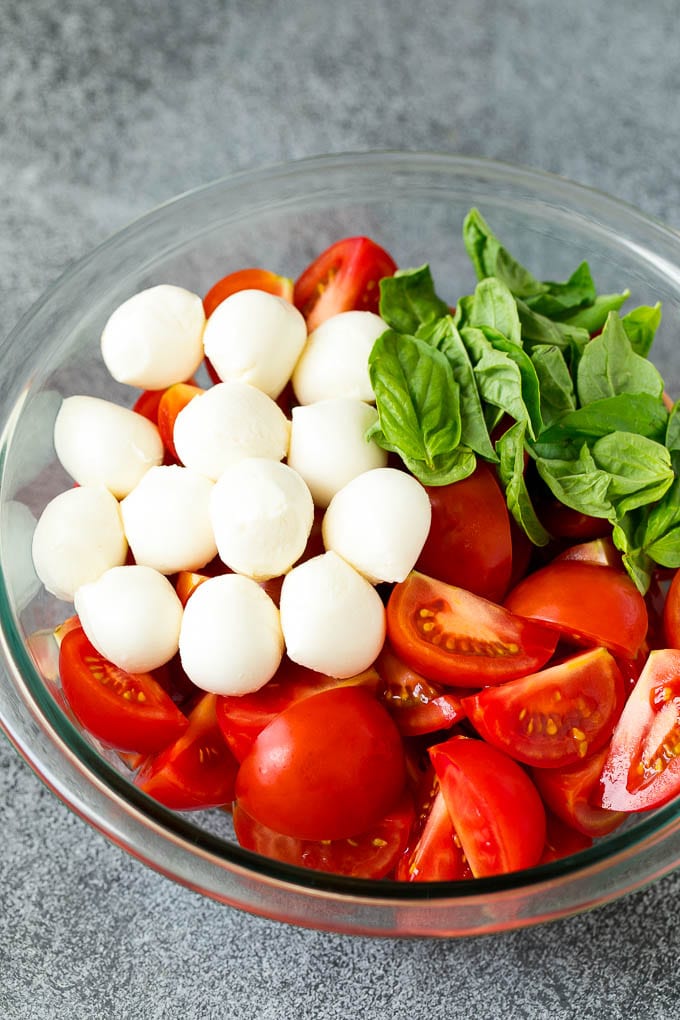 Caprese Salad Recipe | Tomato Salad #salad #tomato #mozzarella #cheese #basil #caprese #summer #edsug Tomatoes, mozzarella and basil in a bowl.