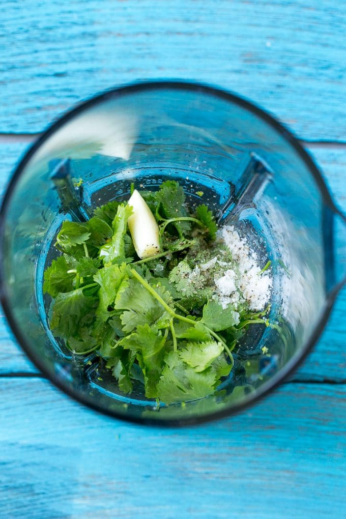 Cilantro Lime Chicken | Grilled Chicken #chicken #grilling #cilantro #lime #dinner #edsug A blender full of cilantro leaves, garlic, lime juice and olive oil.
