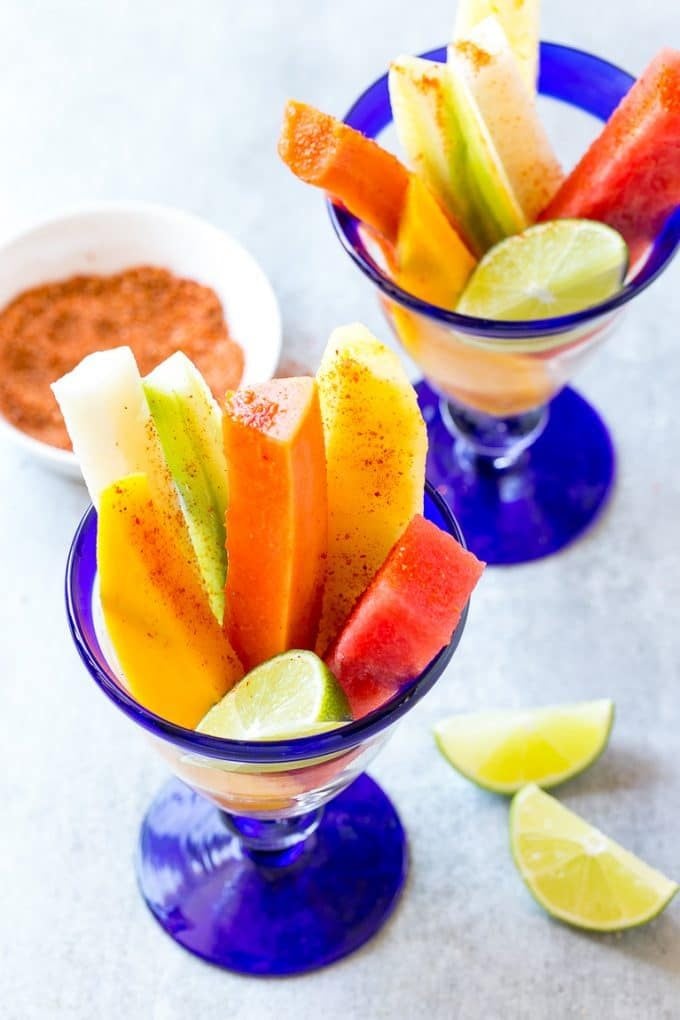 Mexican Fruit Cups | Fruit Cups | Mexican Fruit | Tropical Fruit #fruit #fruitcup #watermelon #pineapple #snack #healthy #edsug Spears of watermelon, cucumber, jicama, mango and pineapple in glasses.