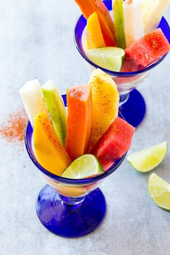 Mexican Fruit Cups | Fruit Cups | Mexican Fruit | Tropical Fruit #fruit #fruitcup #watermelon #pineapple #snack #healthy #edsug Mexican fruit cups with an assortment of fruit, topped with chili lime seasoning.