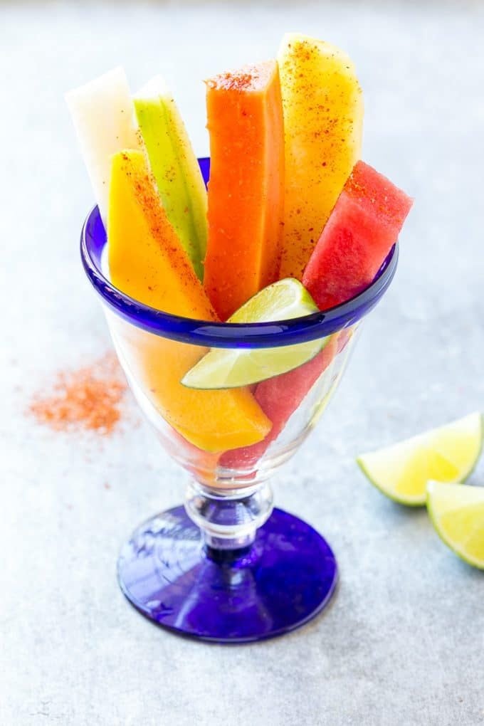 Mexican Fruit Cups | Fruit Cups | Mexican Fruit | Tropical Fruit #fruit #fruitcup #watermelon #pineapple #snack #healthy #edsug Mexican fruit cups topped with chili lime seasoning.
