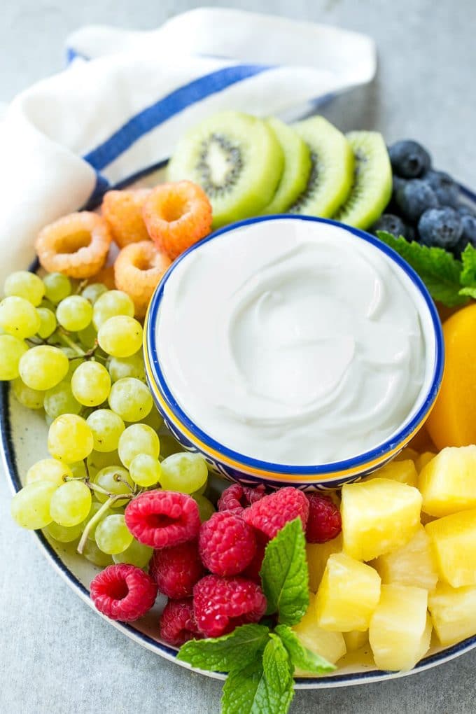 Cream Cheese Fruit Dip | Fruit Recipe | Fruit Dip #fruit #dip #creamcheese #snack #dessert #edsug A bowl of cream cheese fruit dip surrounded by colorful fruit.