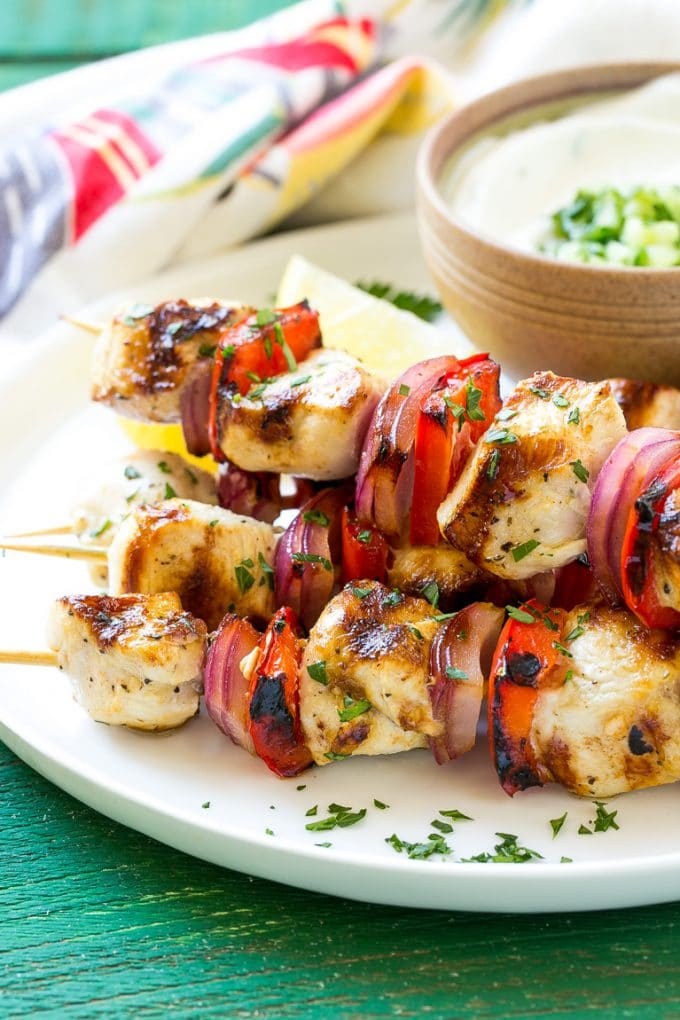 Greek Chicken Kabobs | Grilled Chicken Kabobs | Healthy Chicken Recipe | Greek Chicken #greekfood #chicken #grilling #grilledchicken #kabobs #dinner #edsug A stack of Greek chicken skewers made with peppers and onions.