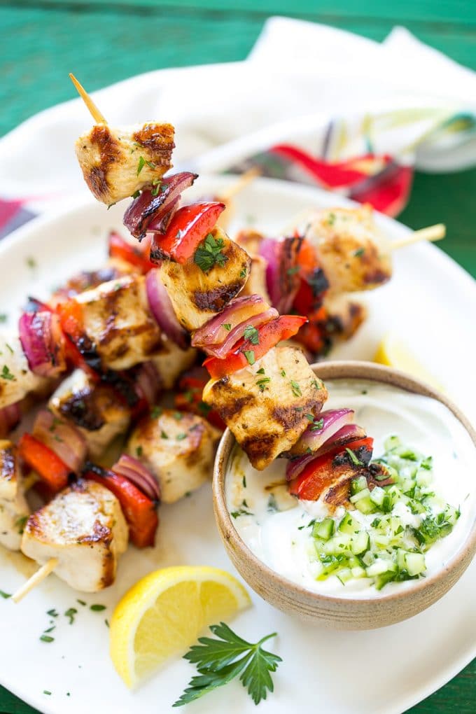 Greek Chicken Kabobs | Grilled Chicken Kabobs | Healthy Chicken Recipe | Greek Chicken #greekfood #chicken #grilling #grilledchicken #kabobs #dinner #edsug Skewered meat and veggies being dipped onto cucumber yogurt sauce.