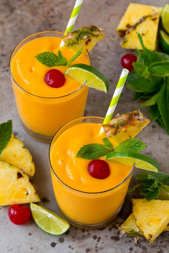 Tropical Smoothie Recipe | Mango Smoothie | Pineapple Smoothie #smoothie #mango #pineapple #banana #drink #edsug Tropical smoothie garnished with mint, limes and pineapple.