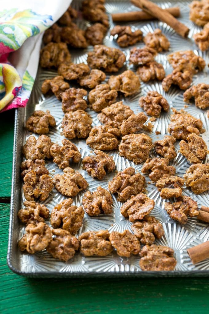 Candied Walnuts Recipe | Candied Nuts | Glazed Walnuts | Cinnamon Sugar Walnuts #walnuts #dessert #snack #edsug A sheet pan with a layer of glazed walnut halves.
