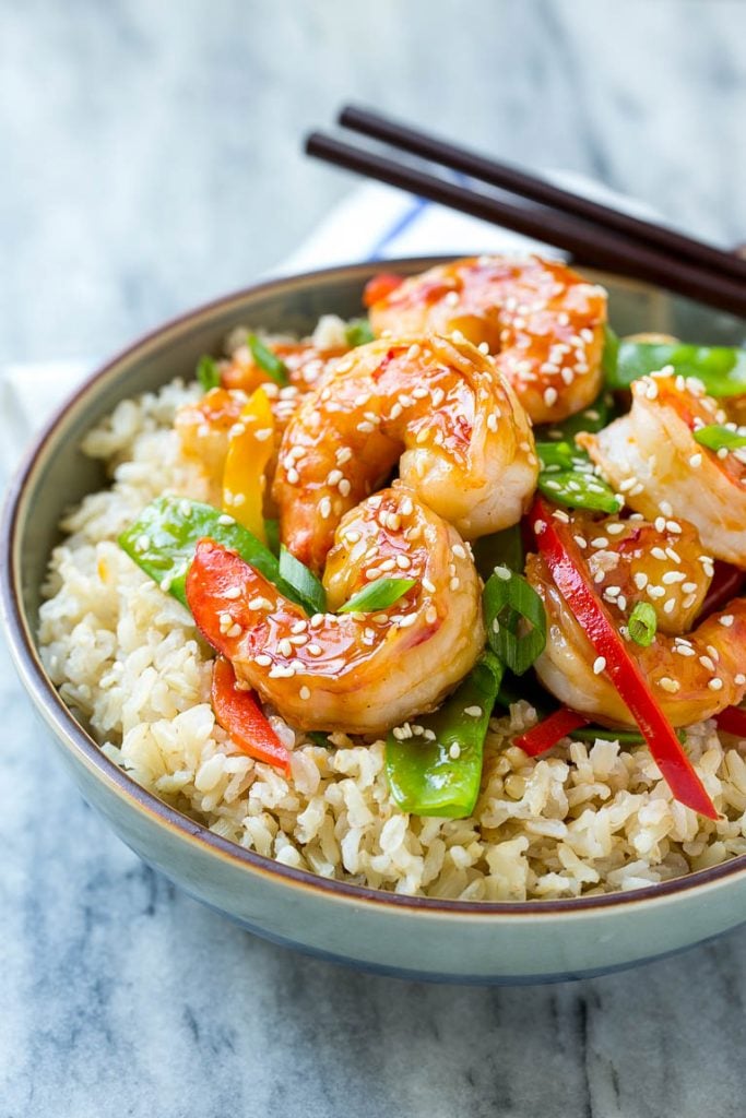 Teriyaki Shrimp Stir Fry Recipe | Shrimp Stir Fry | Healthy Stir Fry #shrimp #teriyaki #vegetables #stirfry #dinner #edsug A bowl of shrimp stir fry and vegetables garnished with sesame seeds.