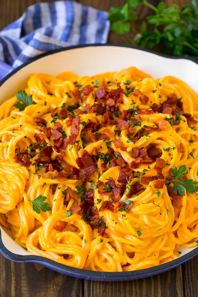 Butternut Squash Pasta Recipe #pasta #squash #bacon #fall #dinner #edsug Butternut squash pasta in a skillet topped with bacon and parsley.