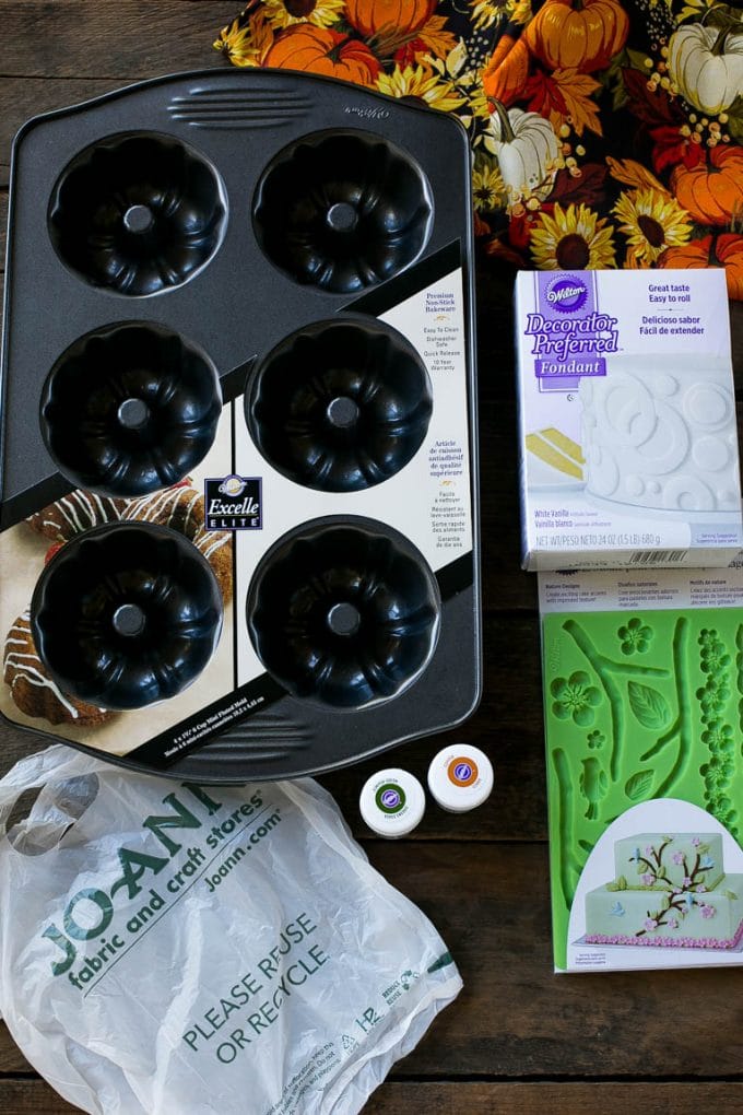 Pumpkin Spice Cake Recipe | Pumpkin Cake | Easy Pumpkin Cake | Thanksgiving Dessert #thanksgiving #pumpkin #cake #pumpkincake #spicecake #dessert #edsug #holiday Cake making tools including fondant, a cake pan, tubs of gel food color and fondant molds.
