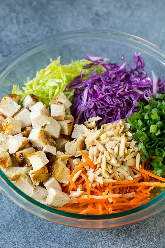 Chinese Chicken Salad Recipe | Asian Chicken Salad #salad #chicken #chickensalad #cabbage #lunch #dinner #edsug Cabbage, carrots, chicken, almonds and green onions in a bowl.