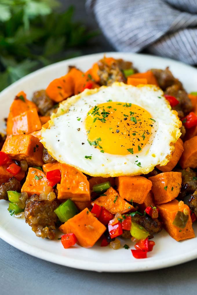 Sweet Potato Hash #sweetpotato #sausage #breakfast #brunch #edsug Sweet potato hash with sausage, topped with a fried egg.