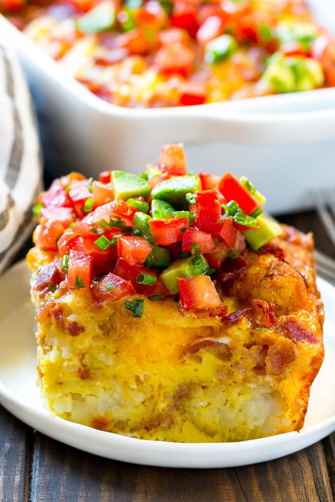 Breakfast Casserole with Bacon Recipe | Bacon and Egg Casserole | Egg Casserole with Bacon | Bacon Breakfast Casserole #eggs #bacon #casserole #breakfast #brunch #edsug A slice of egg casserole with potato tots in it.