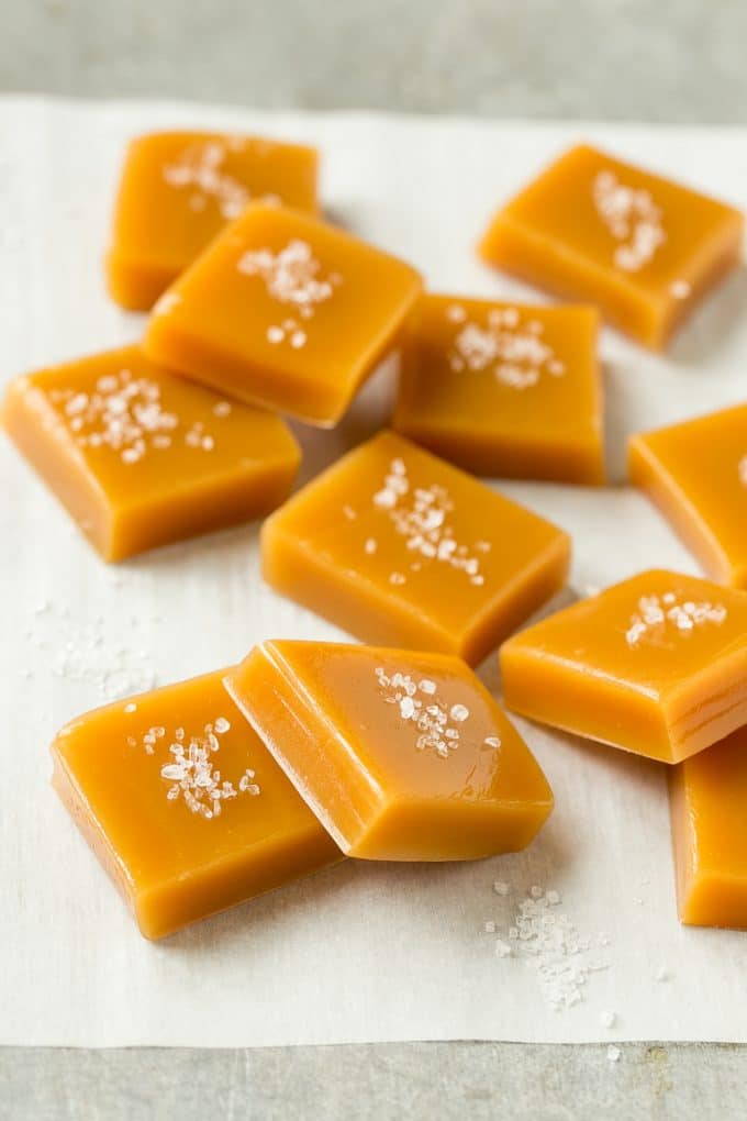 Microwave Caramels with Sea Salt Recipe | Homemade Caramels | Sea Salt Caramel | Homemade Candy #candy #caramels #caramel #microwavecaramels #homemade #dessert #edsug Squares of caramel topped with coarse salt.