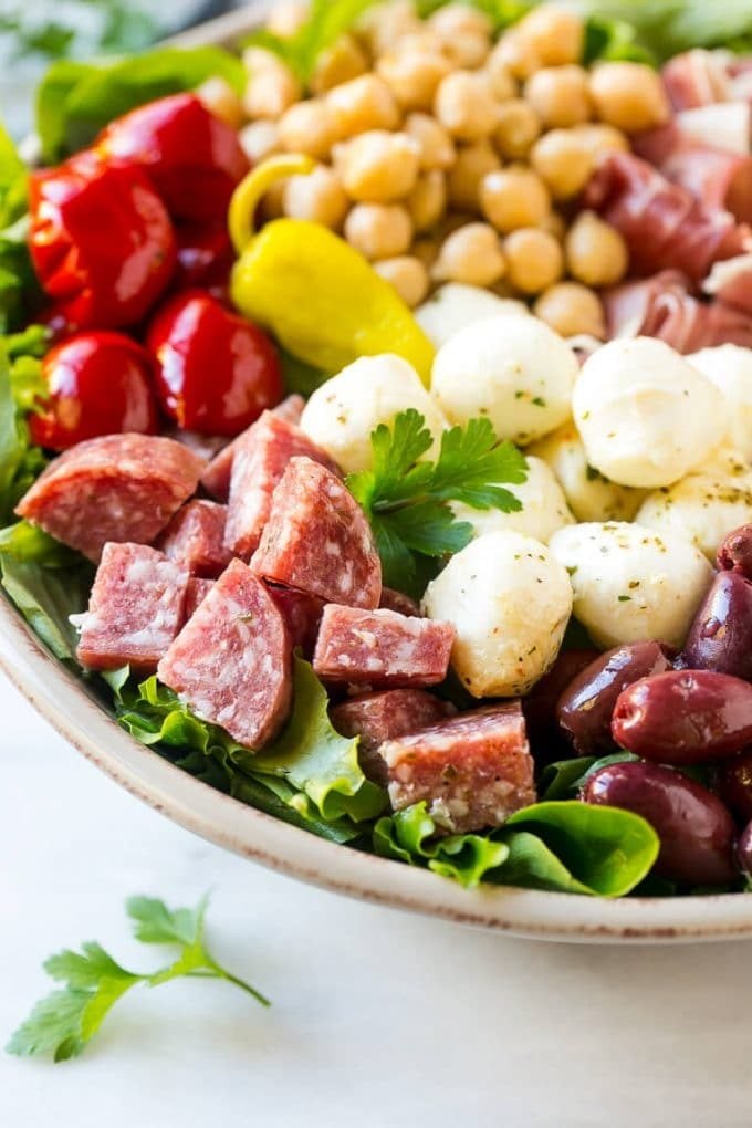 Antipasto Salad Recipe | Italian Salad | Main Course Salad | Antipasto Recipe #salad #salami #italianfood #dinner #lunch #edsug A bed of greens topped with antipasto salad including meats, cheeses, beans and vegetables.
