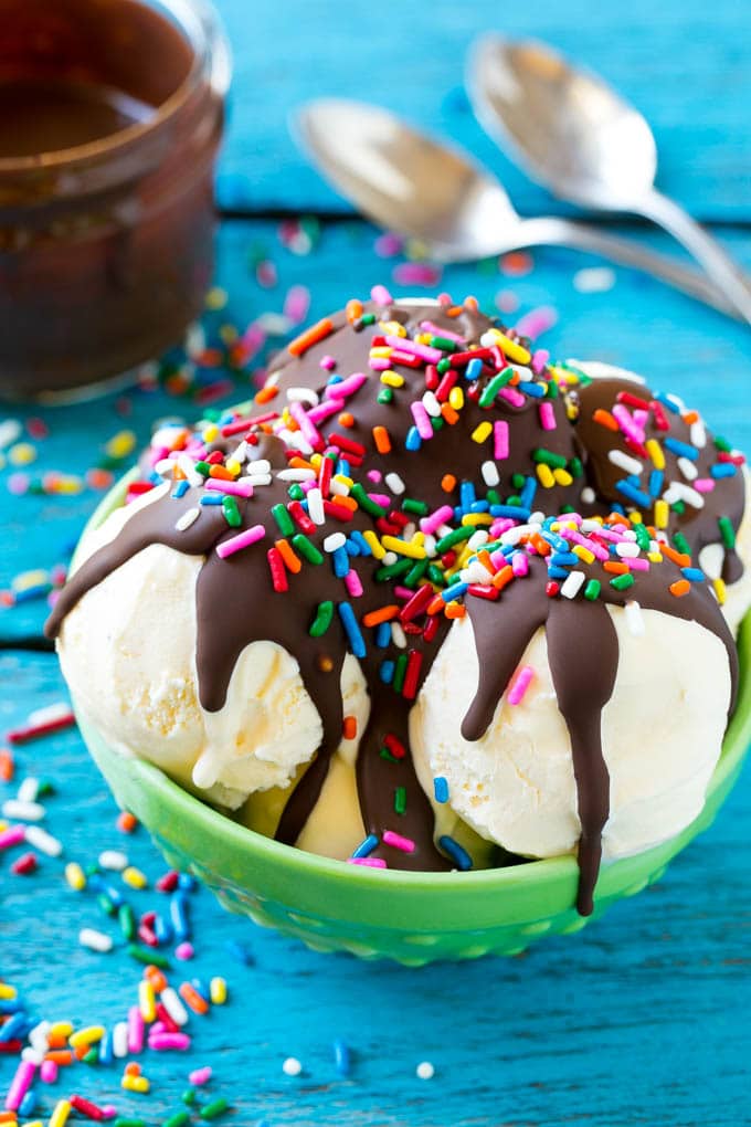 Homemade Magic Shell Recipe | Chocolate Ice Cream Topping | Chocolate Sauce | Hard Chocolate Coating #chocolate #icecream #dessert #edsug Magic shell over vanilla ice cream with rainbow sprinkles.