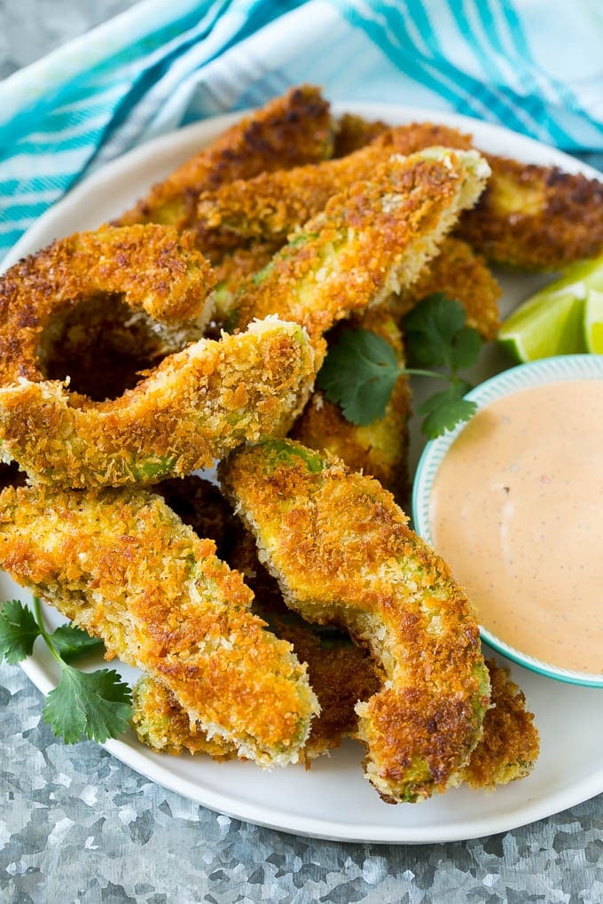 Avocado Fries Recipe | Fried Avocado | Avocado Fritters #avocado #appetizer #snack #edsug A plate of avocado fries served with dipping sauce.