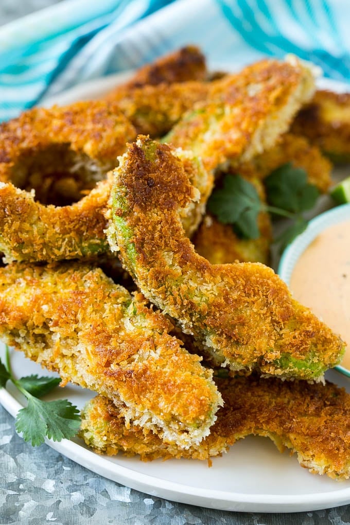 Avocado Fries Recipe | Fried Avocado | Avocado Fritters #avocado #appetizer #snack #edsug A plate of avocado fries garnished with fresh cilantro.