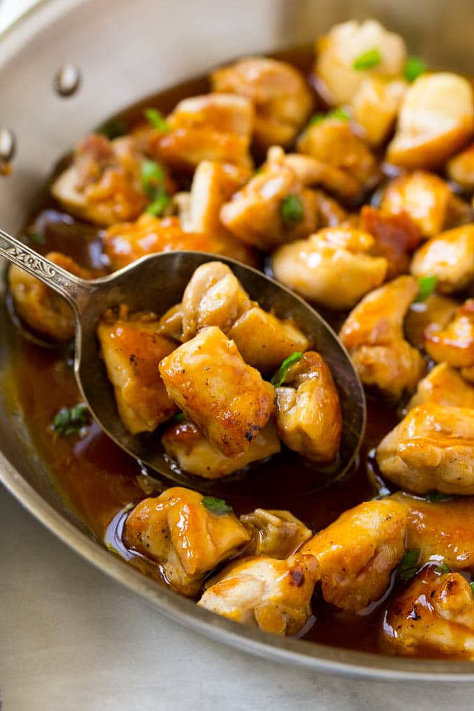 Bourbon Chicken | Sauteed Chicken | Chicken Stir Fry | Easy Chicken Recipe #chicken #dinner #edsug A pan of bourbon chicken with a serving spoon in it.