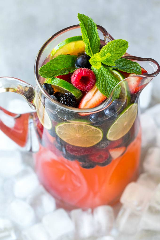 Berry Champagne Punch Recipe | Champagne Cocktail | Lime Cocktail | Berry Punch | Champagne Recipe #champagne #punch #berries #drink #edsug A pitcher of champagne punch filled with fresh berries and mint sprigs.