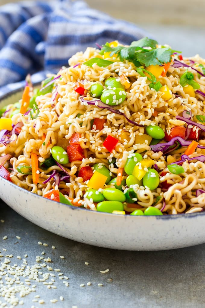 Asian Noodle Salad Recipe | Ramen Noodle Salad | Asian Salad #salad #noodles #edamame #vegetarian #edsug #lunch A mixture of ramen noodles, carrots, edamame, cabbage and peppers in a serving bowl.