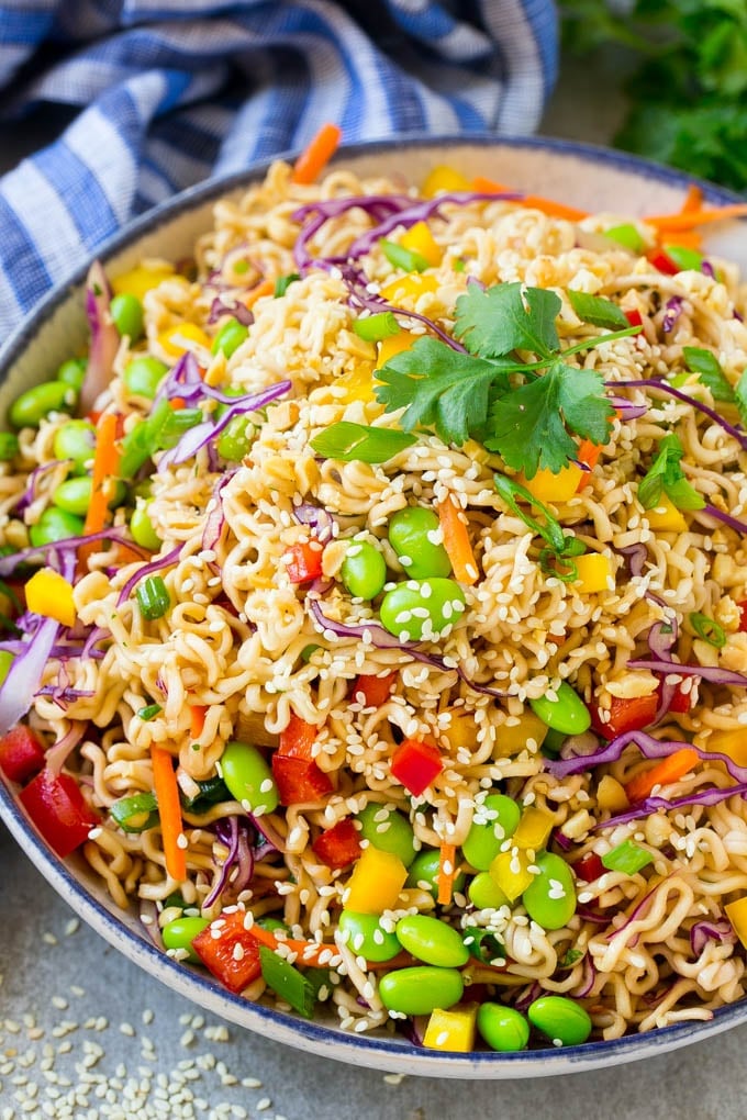 Asian Noodle Salad Recipe | Ramen Noodle Salad | Asian Salad #salad #noodles #edamame #vegetarian #edsug #lunch A bowl of Asian noodle salad with colorful vegetables.