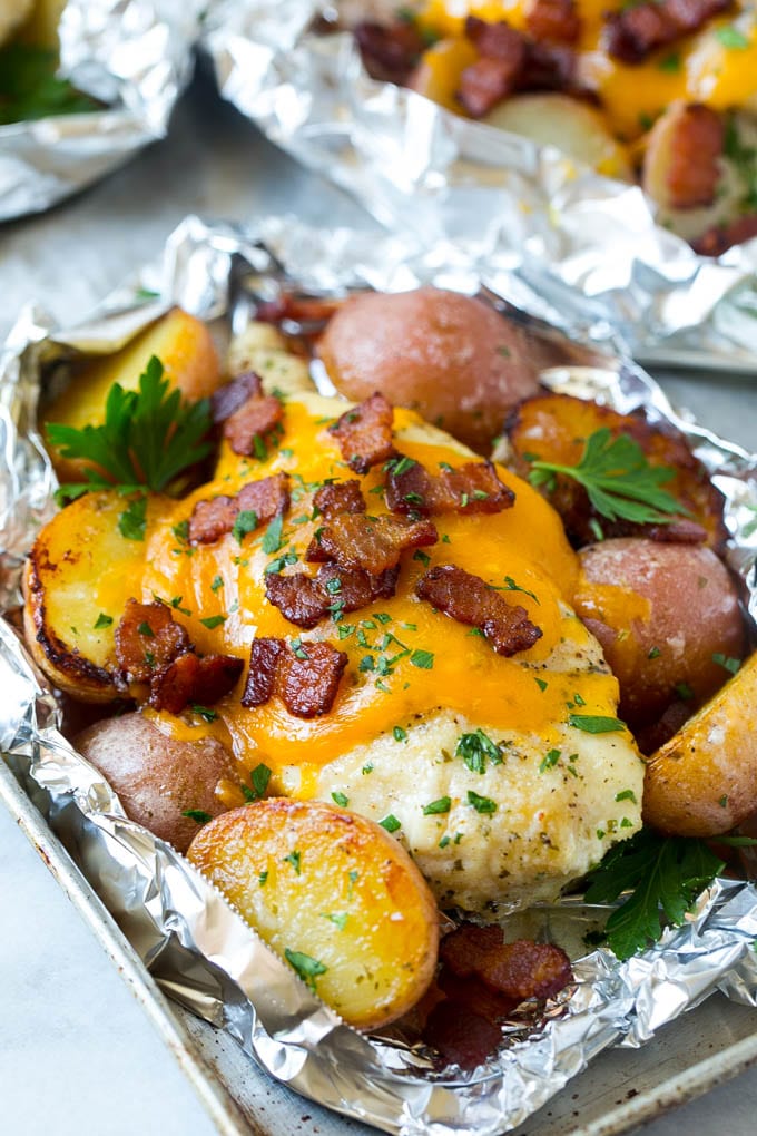 Bacon Ranch Chicken Foil Packets | Chicken in Foil | Foil Packet Recipe | Ranch Chicken #ranchchicken #grilling #chicken #foilpacket #foilpackets #bacon #dinner #edsug Chicken in foil topped with cheddar cheese and bacon.